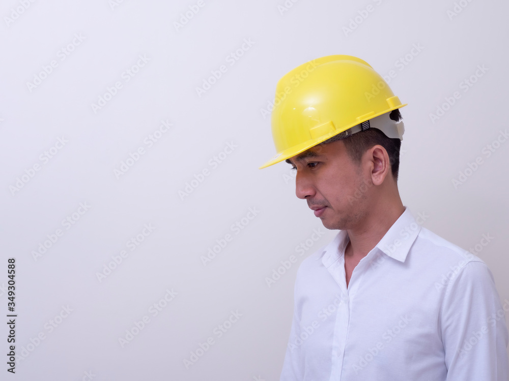 engineer with hands crossed wearing yellow helmet on white background engineer with hands crossed wearing yellow helmet on white background
