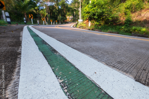 .empty winding road in jungle between Coconut palms in tropical island Ko Pha Ngan to Haad Sadet Beach photo