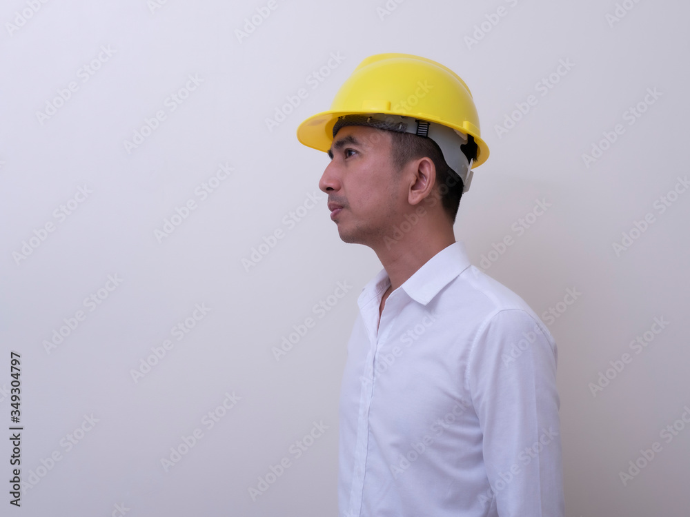 engineer with hands crossed wearing yellow helmet on white background engineer with hands crossed wearing yellow helmet on white background