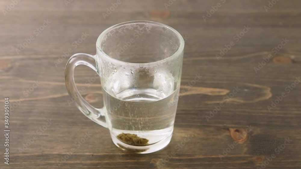 Herbal medicine tablet dissolving in a hot water. Stirring with teaspoon. Sequence of 1 second cuts. Concept for self-medication and natural medicine
Herbal medicine tablet dissolving in a hot water. Stirring with teaspoon. Sequence of 1 second cuts. Concept for self-medication and natural medicine