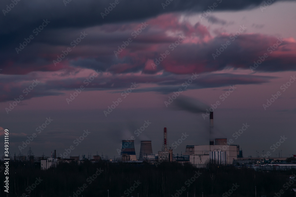 Picturesque pink sunset over a power plant. Chimneys of the southern thermal power plant in St. Petersburg.