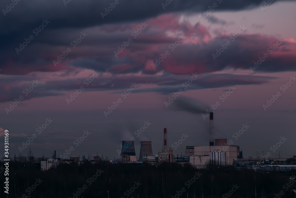 Picturesque pink sunset over a power plant. Chimneys of the southern thermal power plant in St. Petersburg. Picturesque pink sunset over a power plant. Chimneys of the southern thermal power plant in St. Petersburg.