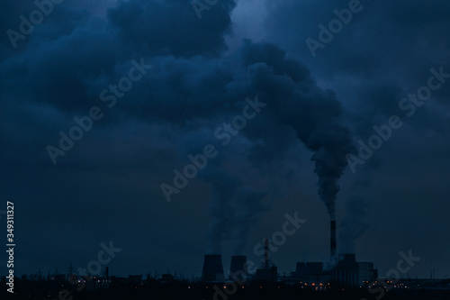 Night view of the smoking pipes of a power plant. 