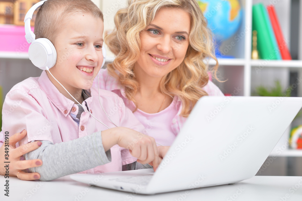 Portrait of mother and son using laptop together Portrait of mother and son using laptop together