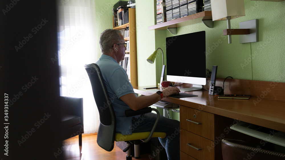 Caucasian man telecommuting in workplace Caucasian man telecommuting in workplace