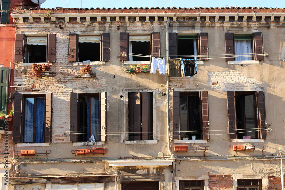 old building in venice on a canal with laundry out the window