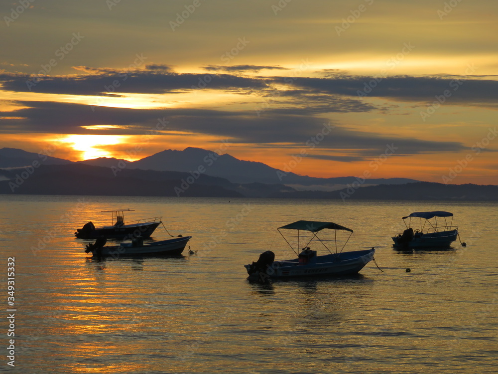 Sunrise in a bay with boats, mountains, Costa Rica