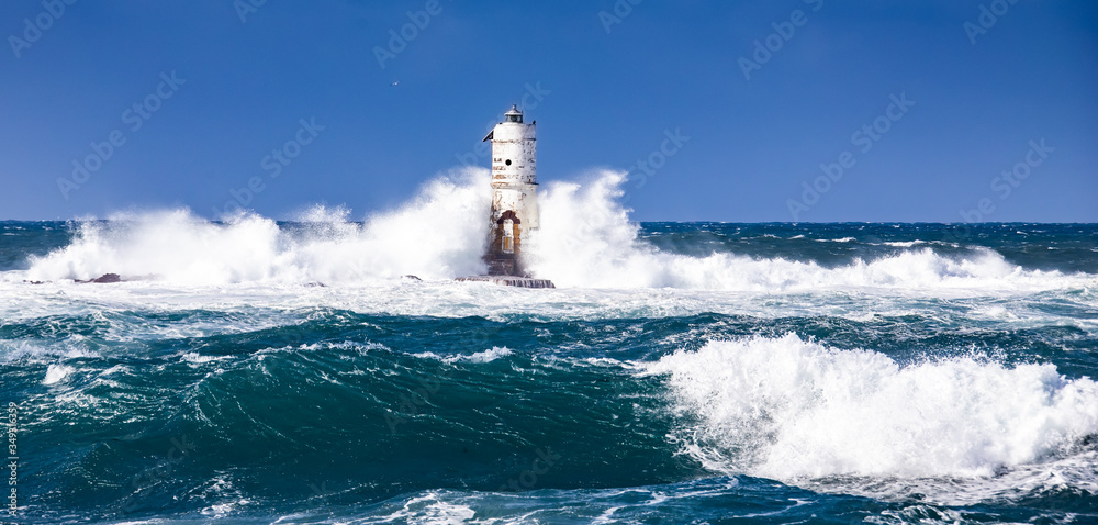 The lighthouse of the Mangiabarche shrouded by the waves of a mistral wind storm