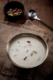 Kheer or Payasam is a type of rice pudding from the Indian subcontinent, made by boiling milk and sugar and is flavoured with dry fruits and nuts, served in metal bowl.