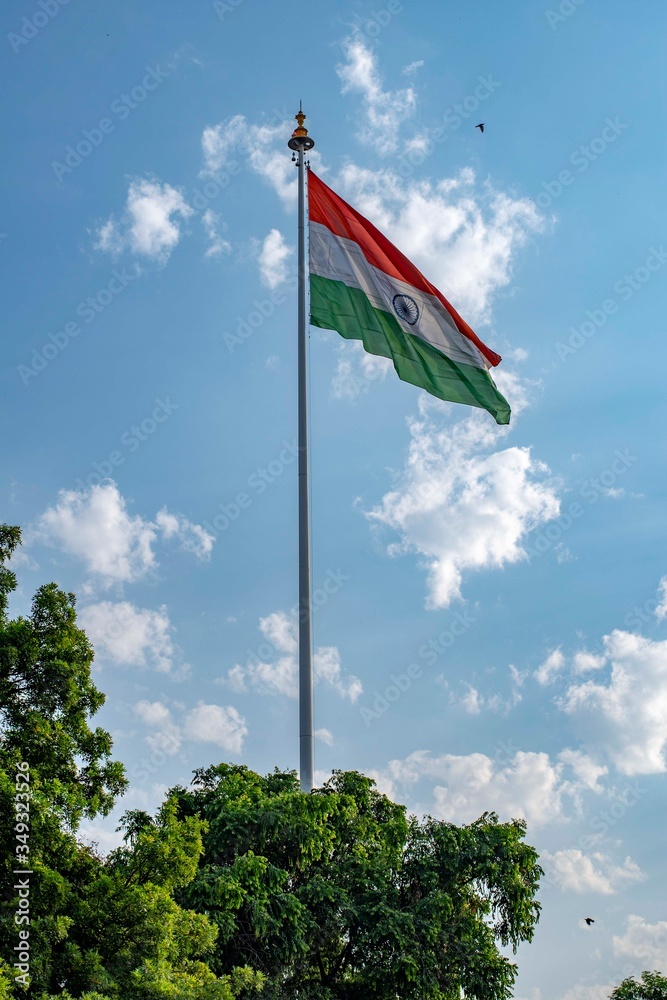 Indian national flag hoisted in the blue cloudy sky on 74th Indian independence day
