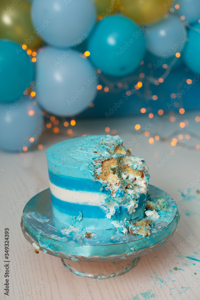 bitten off blue striped cake on a stand bitten off blue striped cake on a stand