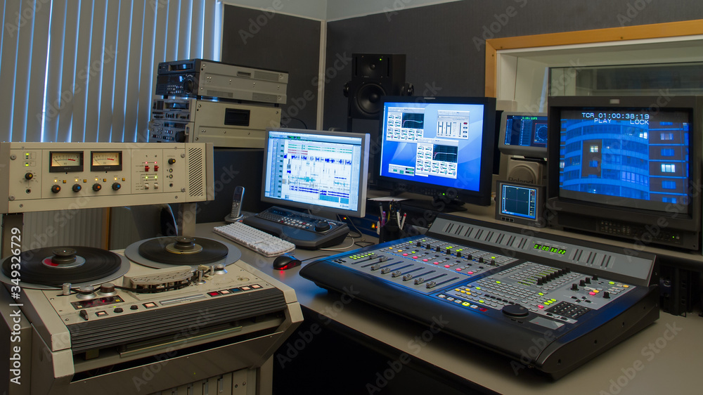 Professional analog tape recorde in TV production studio interior.