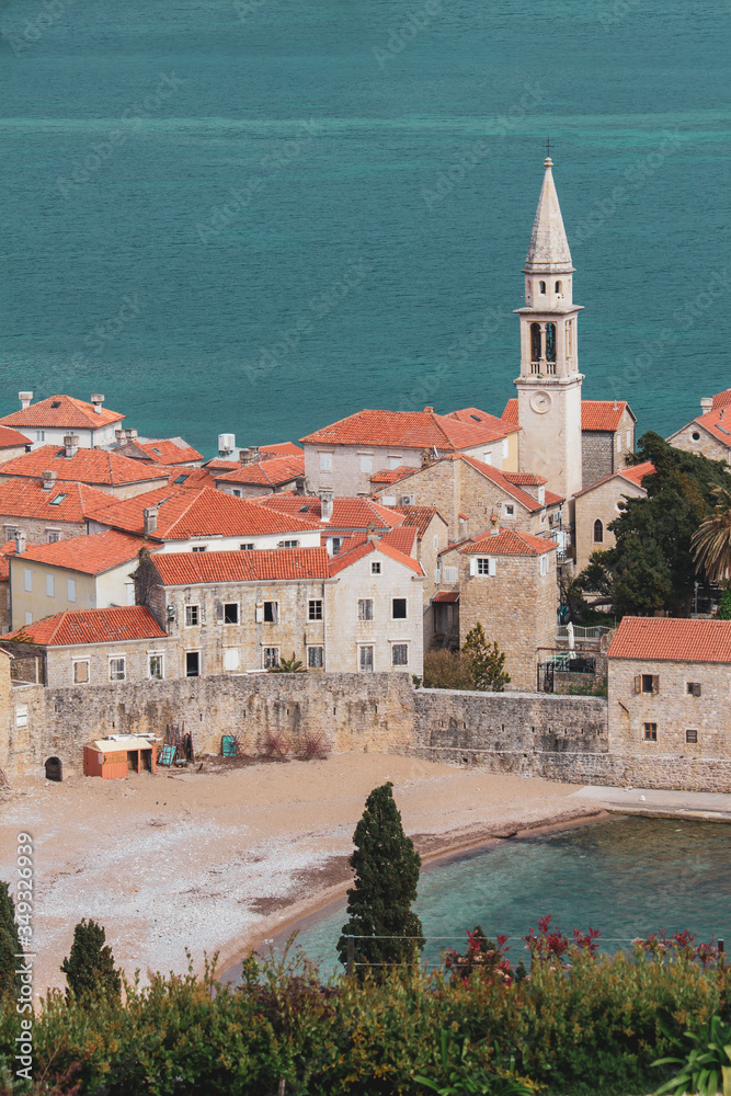 View of the Old Town of Budva. The roofs of the ancient city. Bay and beach near the stone walls