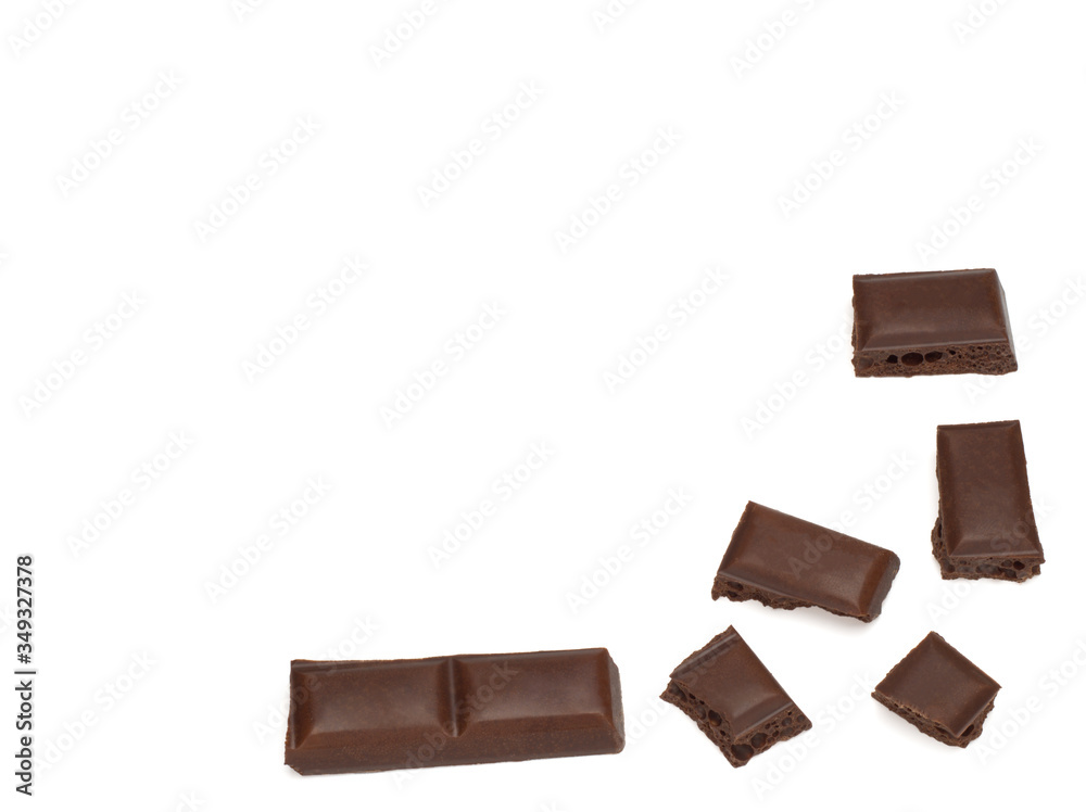 close up of dark porous chocolate pieces on white background close up of dark porous chocolate pieces on white background