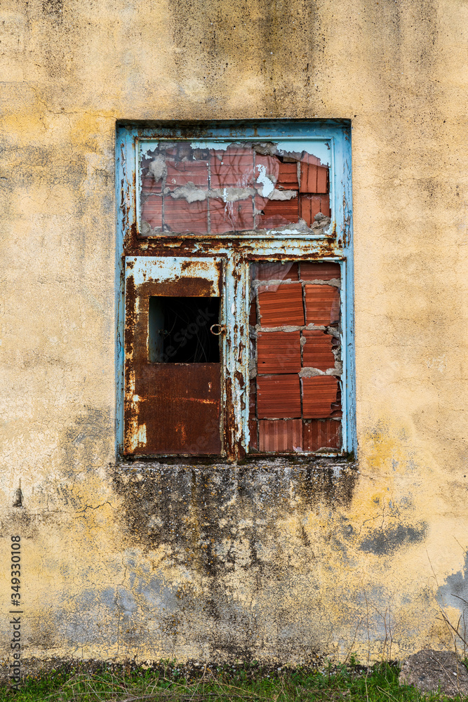 Old brick wall painted. Window patched with red brick Old brick wall painted. Window patched with red brick