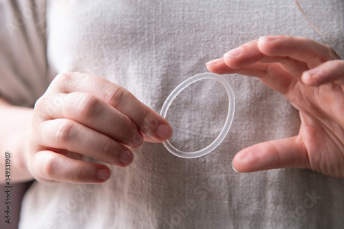 Woman's hand holding a birth control ring, vaginal ring for contraceptive photo