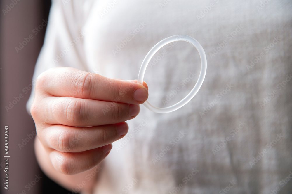 Woman's hand holding a birth control ring, vaginal ring for contraceptive Woman's hand holding a birth control ring, vaginal ring for contraceptive