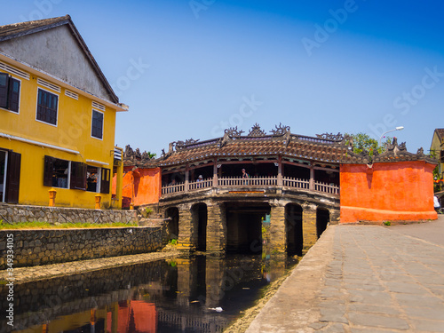 HOIAN, VIETNAM, SEPTEMBER, 04 2017: Unidentified people crossing Traditional boats in front of ancient architecture in Hoi An, Vietnam. Hoi An is the World's Cultural heritage site, famous for mixed