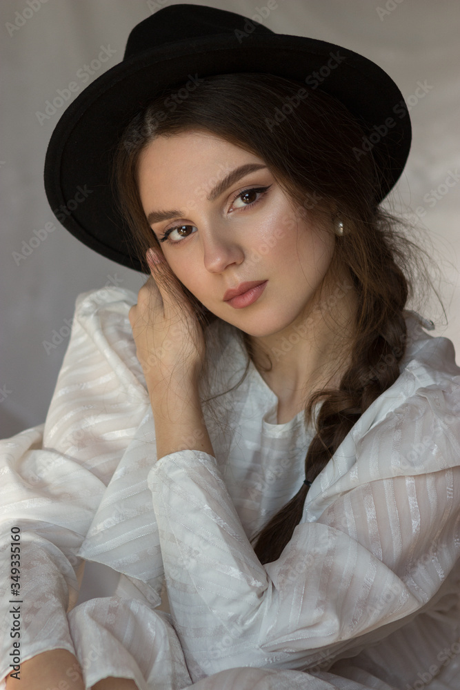 Close-up portrait of a charming bride in lace dress and elegant black hat. Wedding. Make-up and hairstyle Close-up portrait of a charming bride in lace dress and elegant black hat. Wedding. Make-up and hairstyle