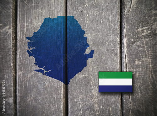 Map and flag of Sierra Leone on a wooden background. photo