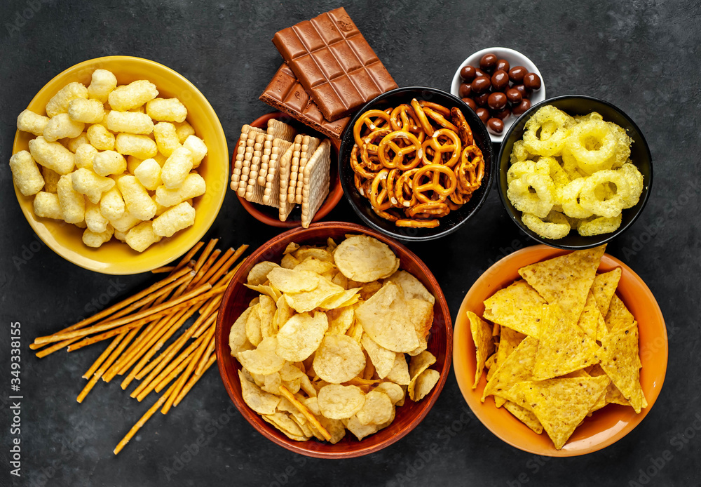Unhealthy food. pretzels different chips, crackers, chicolad, cookies