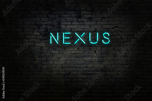 Billede på lærred Neon sign with inscription nexus against brick wall