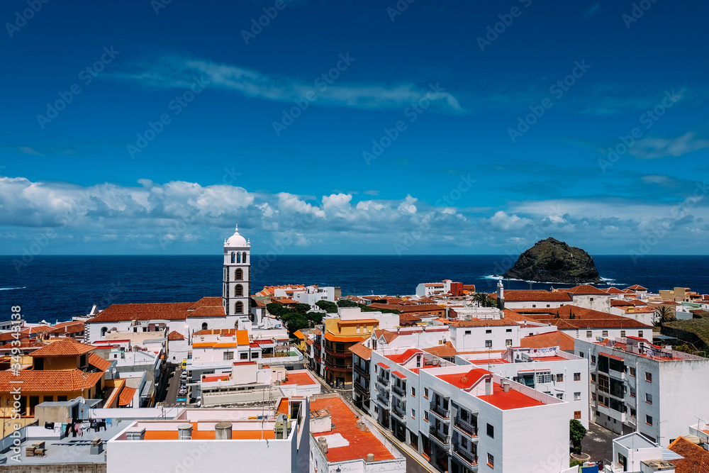 Panorama of the city of Garachico from above on the background of the ocean. The island of Tenerife in the spring on a Sunny day. A town on a tropical island in Spain