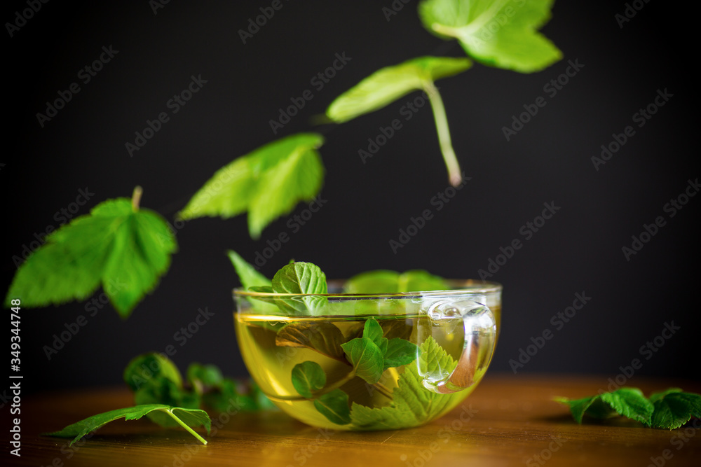 summer refreshing organic tea from currant leaves in a glass teapot summer refreshing organic tea from currant leaves in a glass teapot