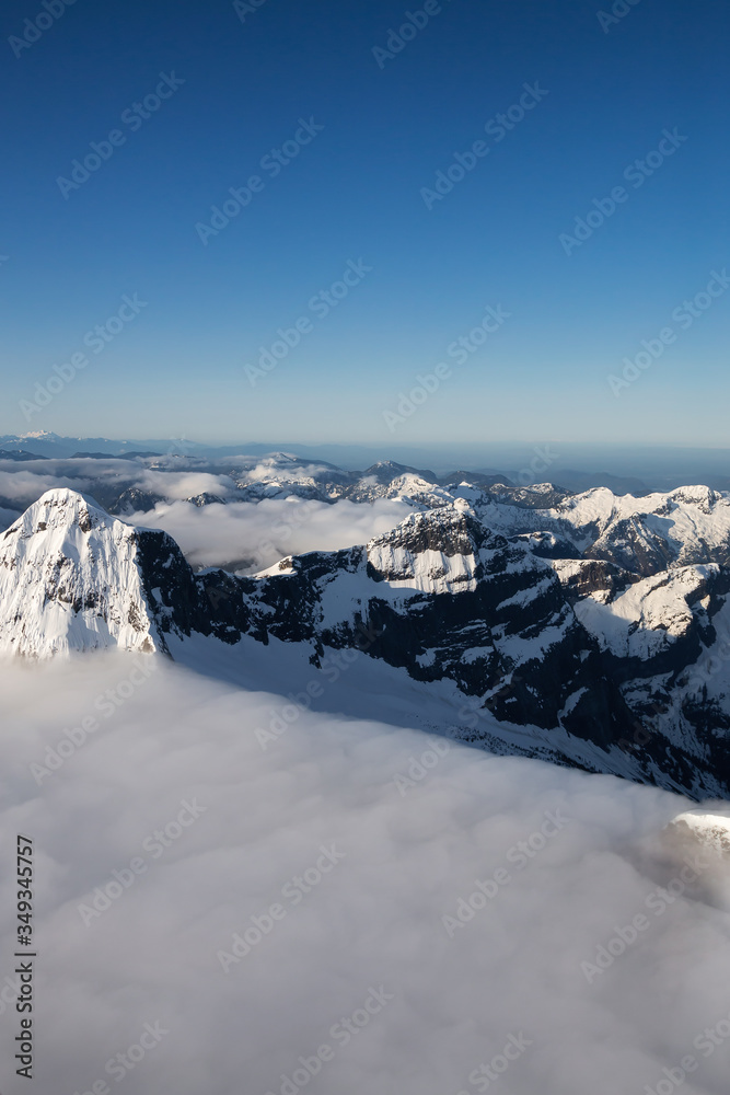 Obraz premium Aerial View of Remote Canadian Mountain Landscape during sunny sunrise. Located near Vancouver, British Columbia, Canada. Nature Background. Authentic