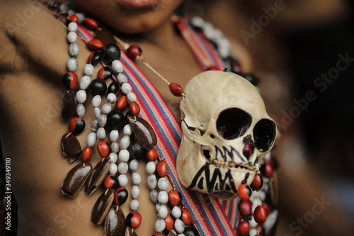 Close shot of an Indian boy's chest with monkey skull photo
