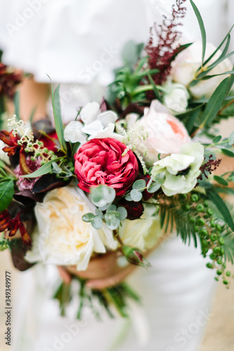 Close-up bouquet of flowers in women s hands. style  floral arranging  wedding concept.