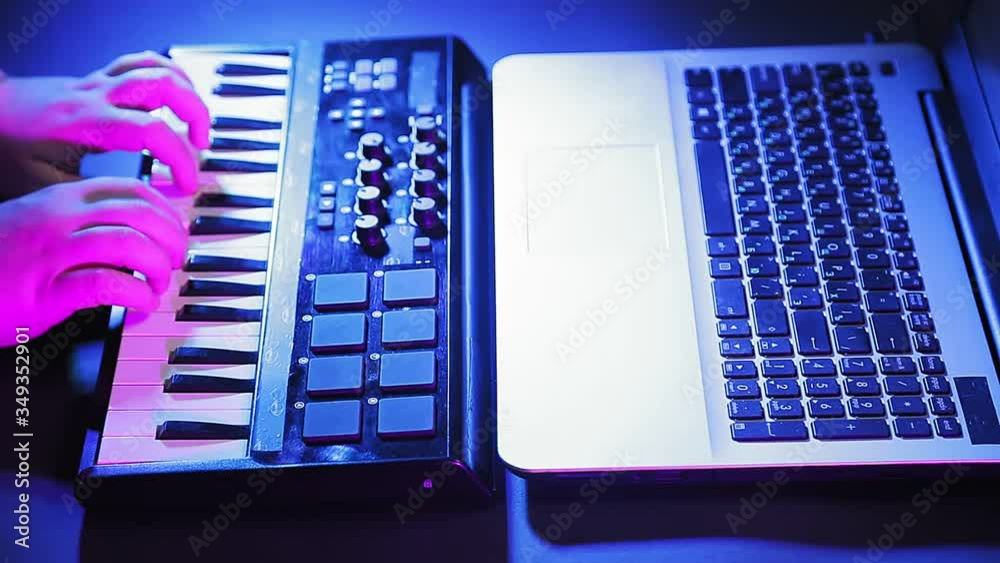 Female hands play on a midi keyboard while recording music on a computer. Female hands play on a midi keyboard while recording music on a computer.