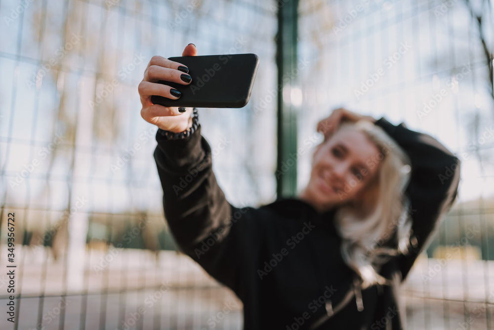 Attractive young lady enjoying sunny day on basketball court