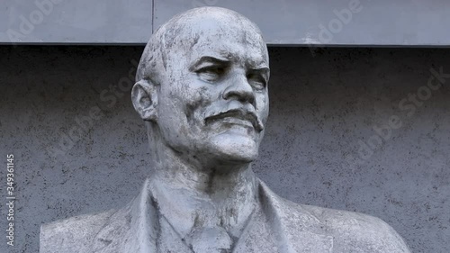 old dirty and abandoned silver lenin statue close-up in the city. sculpture of historical political leader of ussr, symbol of socialism and 
communism