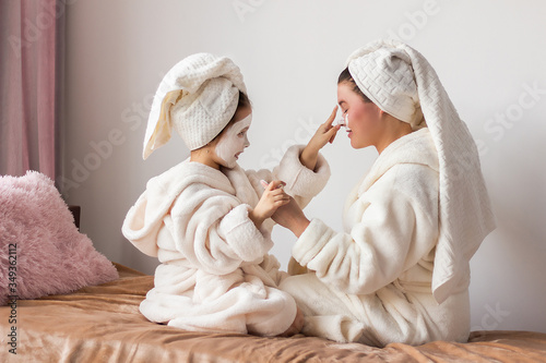 mother and daughter in bathrobes at home