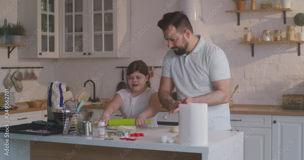 Father and daughter preparing cakes together Father and daughter preparing cakes together