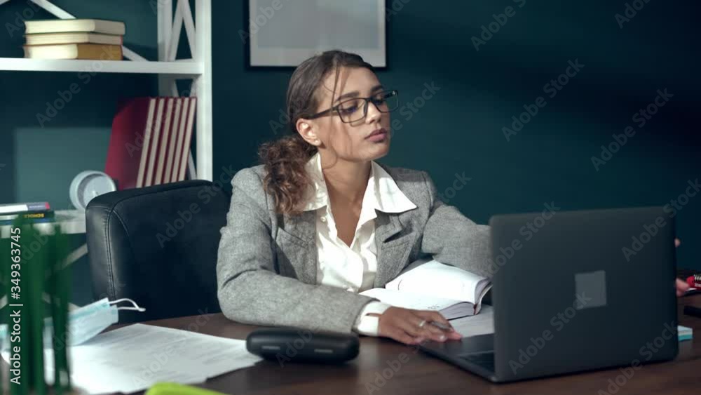 Confident Business Woman Working on a Laptop in Her Modern Office. Stylish Beautiful Woman Doing Important Job. Return to work after quarantine Confident Business Woman Working on a Laptop in Her Modern Office. Stylish Beautiful Woman Doing Important Job. Return to work after quarantine