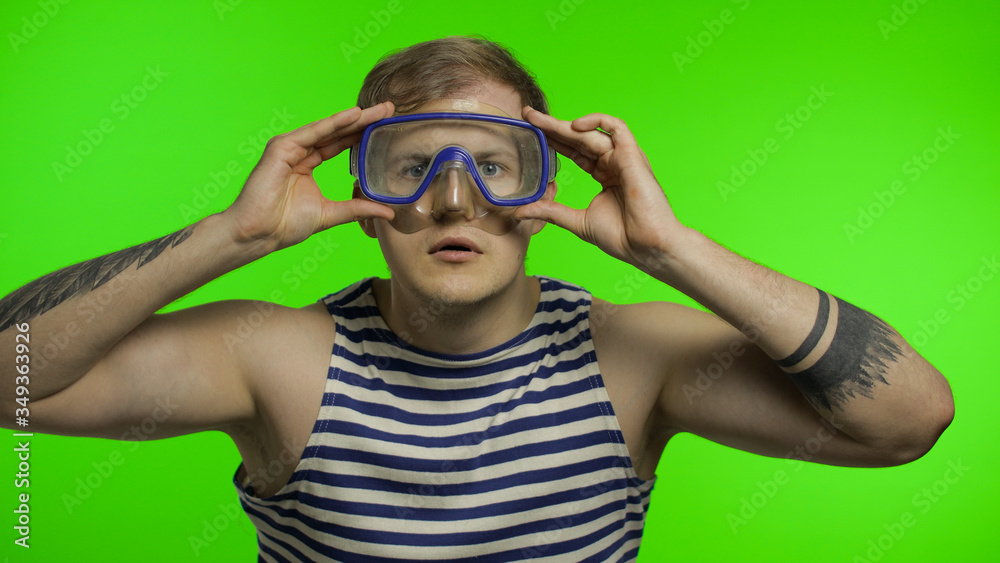 Emotional man tourist in underwater mask, striped sailor shirt on chroma key Emotional man tourist in underwater mask, striped sailor shirt on chroma key