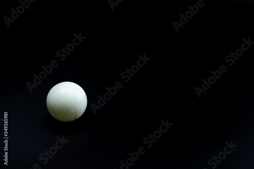 Tennis ball for table tennis on a black background