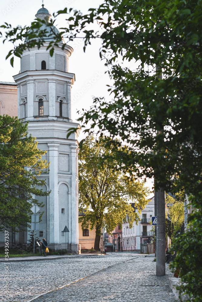 Volyn, Ukraine - May 09,2020: View to Cafedralna street with Saint Peter and Paul Cathedral in Lutsk old city ar sunset,