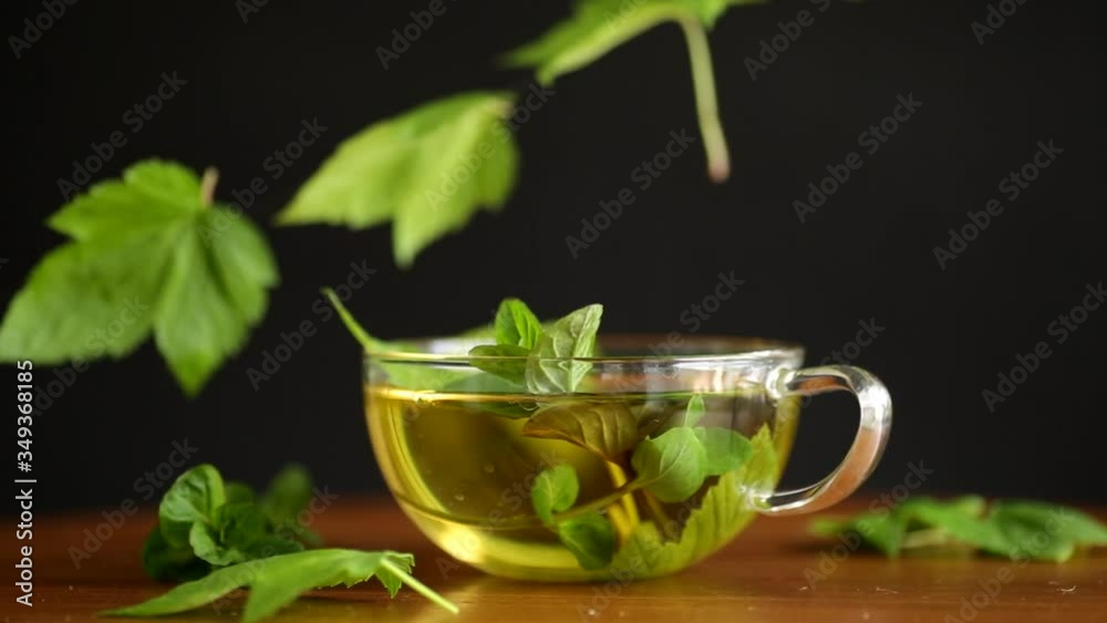 summer refreshing organic tea from currant leaves in a glass teapot