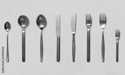 Kitchen cutlery including fork  knife and spoons on a white background