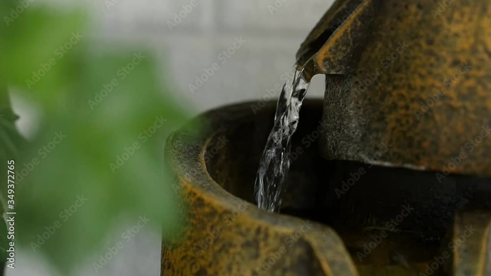 Tabletop traquil indoor water fountain two levels or pools in slow motion. Tabletop traquil indoor water fountain two levels or pools in slow motion.