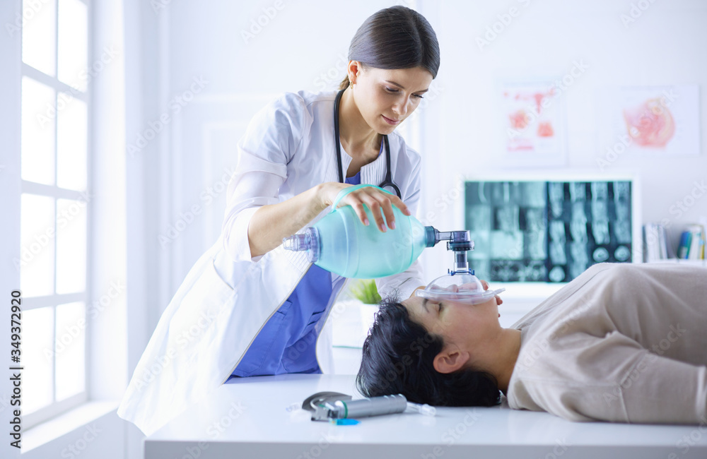 Doctor putting an oxygen mask in the hospital Doctor putting an oxygen mask in the hospital