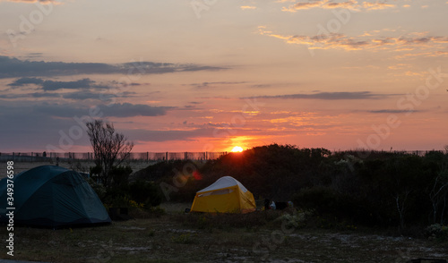 Tent camping near the ocean at sunrise.