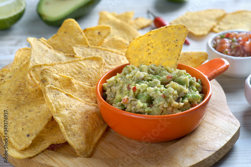 nachos and guacamole on a light background