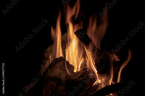 A fire on logs on a dark night