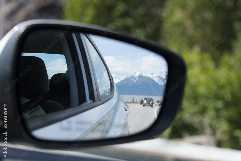View of snow capped mountains from the rear view side view mirror