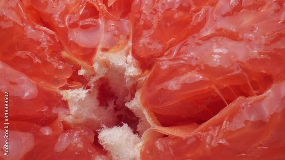 Squeezing a fresh and juicy grapefruit. Close up. Squeezing a fresh and juicy grapefruit. Close up.