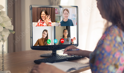 Asian business woman talking to her colleagues about plan in video conference.Online meeting in video call.Online work from home.Stay home for save lives.Technology, Healthcare, People meeting online.